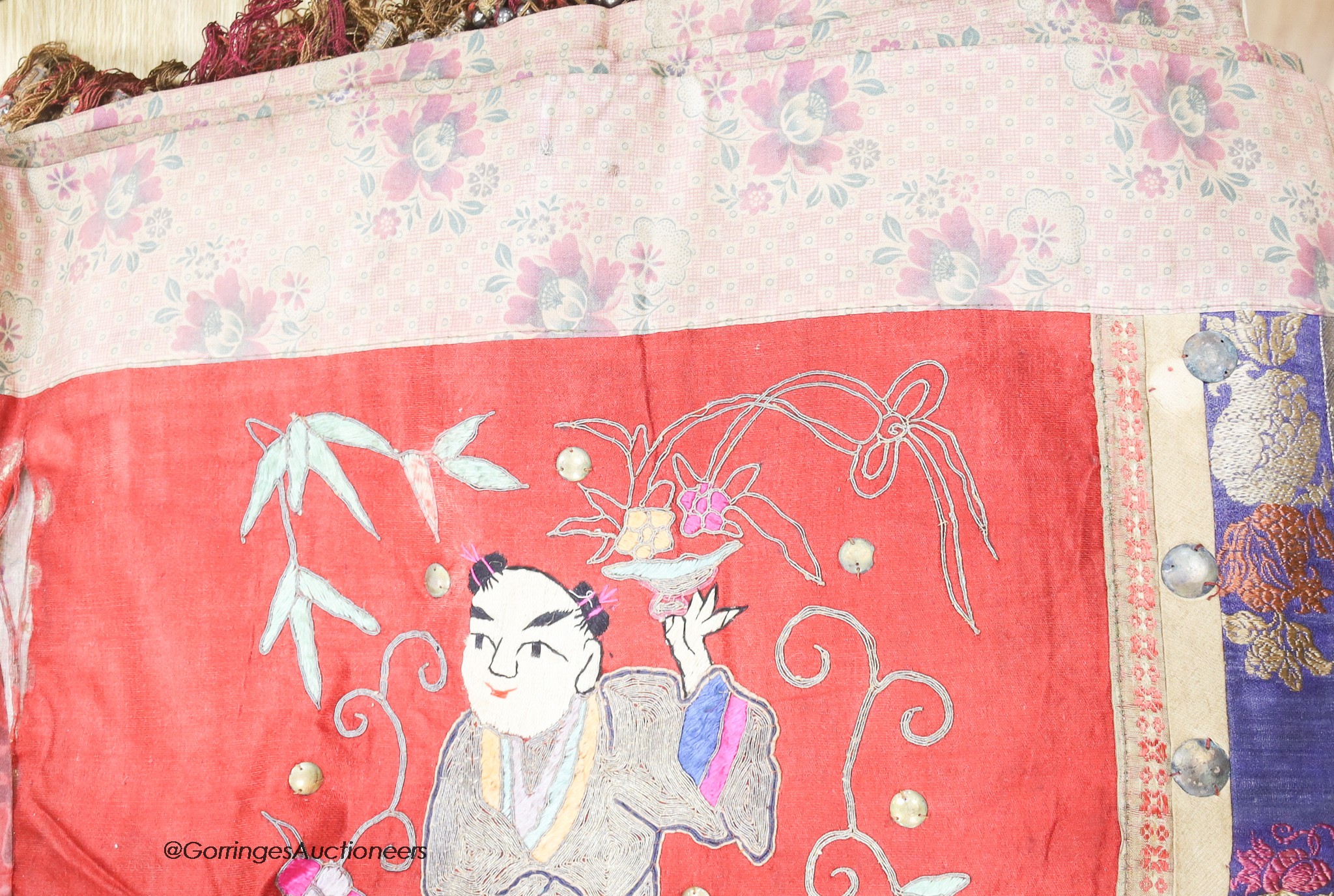 Two Chinese red silk hangings, a mauve damask hanging and a brightly coloured silk panel